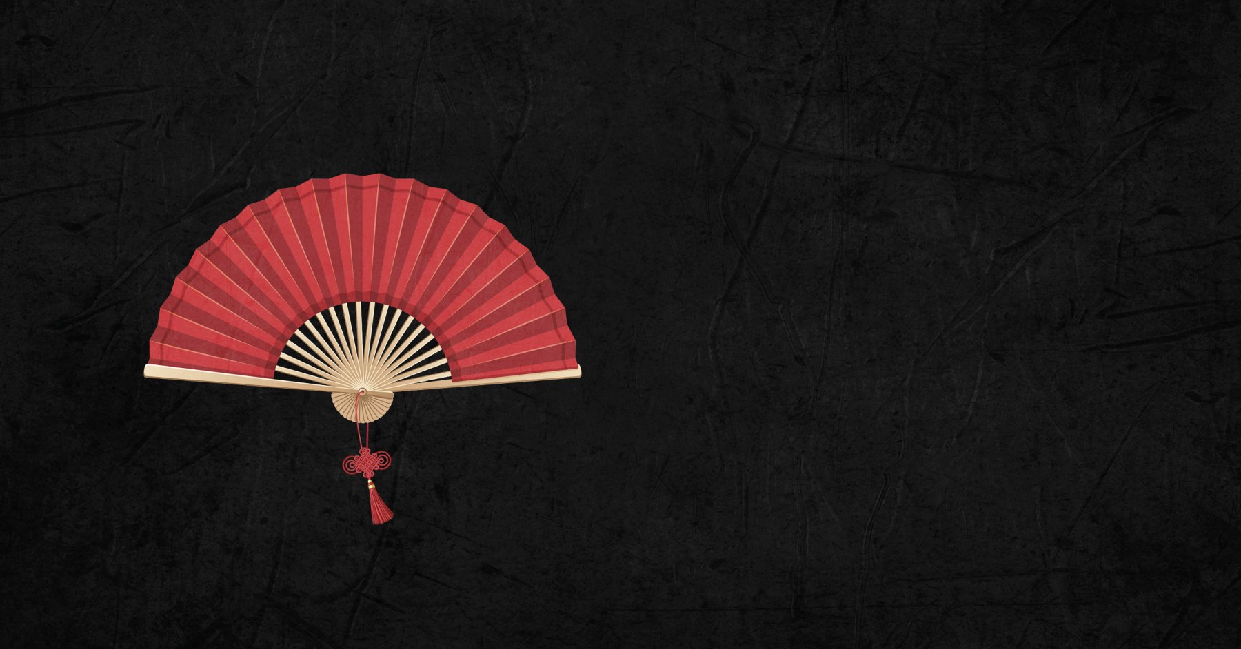 A red traditional Chinese fan on a black backdrop.