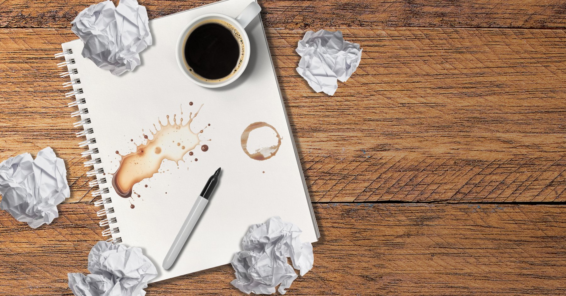 Crumpled papers cover a table with coffee and a pencil for Business Ideas.